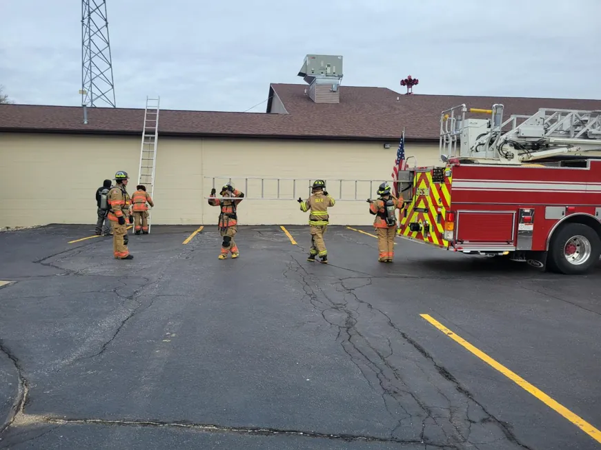 Twin Lakes firefighters setting up ladders from a fire truck